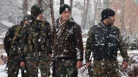 Snow falls on pro-government forces Wednesday in Aleppo.