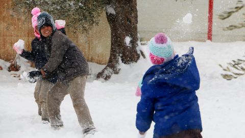 Syrian children throw snowballs this week at a displacement camp in Aleppo province.