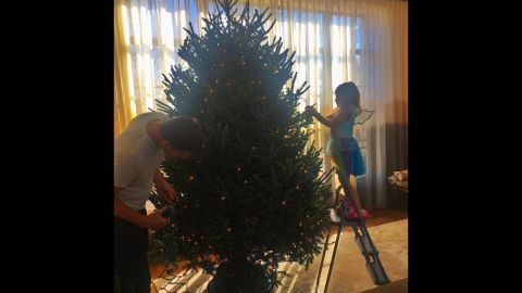 Gisele Bundchen's family is certainly getting into the holiday spirit. The model snapped this adorable photo of hubby Tom Brady decorating their tree with their daughter, Vivian. 