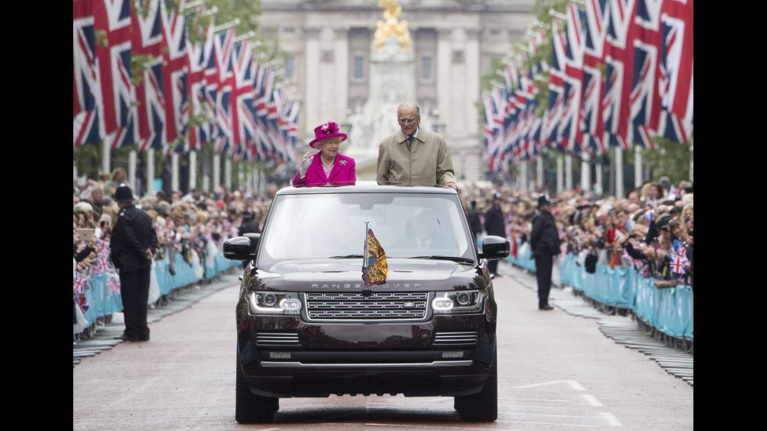 The Queen and Prince Philip wave to guests attending celebrations in London for her 90th birthday in 2016.