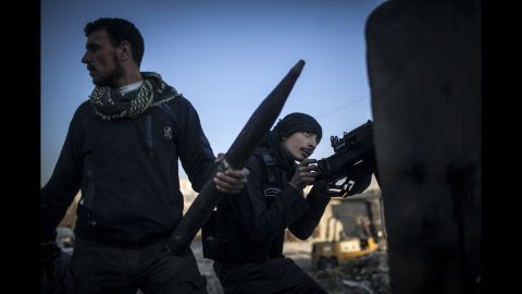 A Free Syrian Army fighter aims his weapon during clashes with government forces in Aleppo on Tuesday, January 15, 2013.