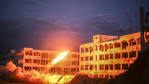 A Syrian opposition tank fires a rocket toward an Assad forces' building during clashes near the Air Intelligence building of Jamiat al-Zahra, Aleppo, on April 13, 2015.