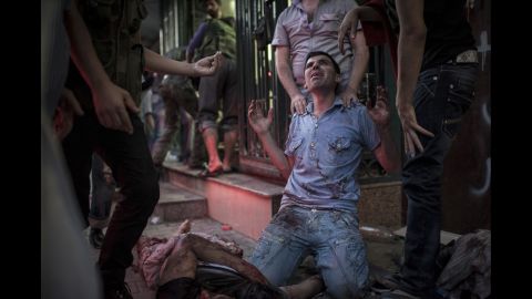 A man in front of a field hospital mourns the death of his relatives on August 21, 2012, in Aleppo.