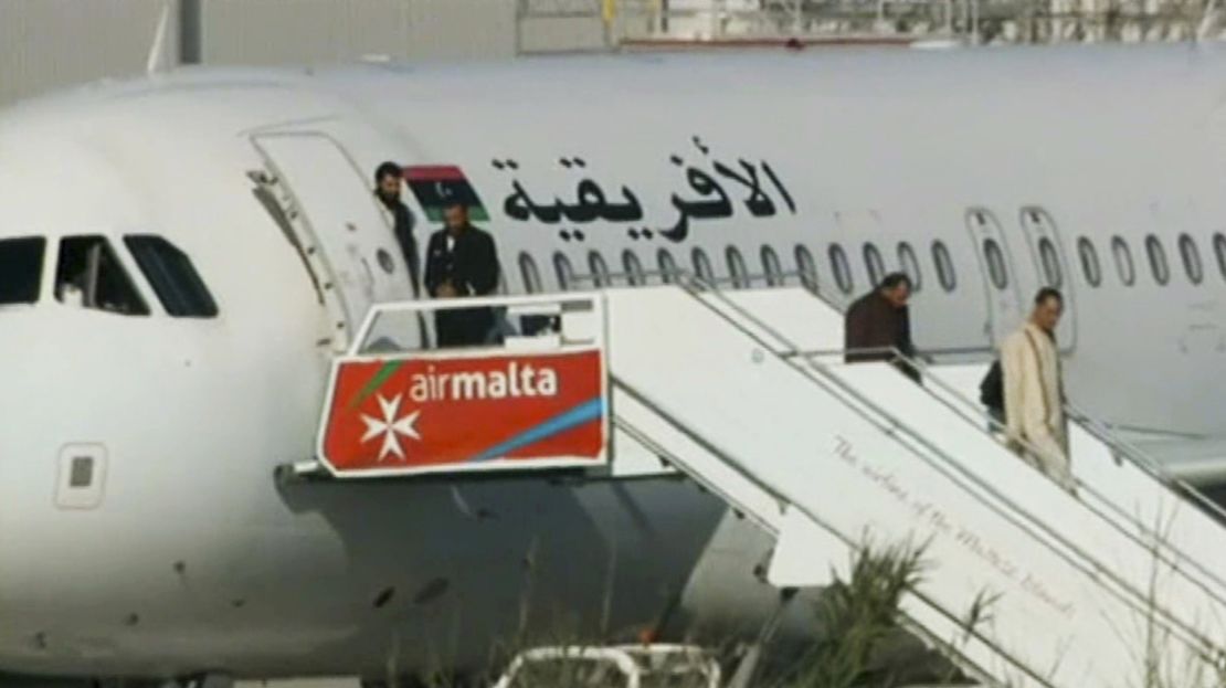 Passengers leave the Afriqiyah Airways jet Friday in Malta while negotiations went on with the hijackers.