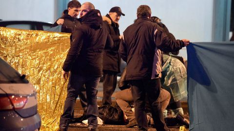 Police and forensics experts gather at the scene of Friday's shootout in Milan.