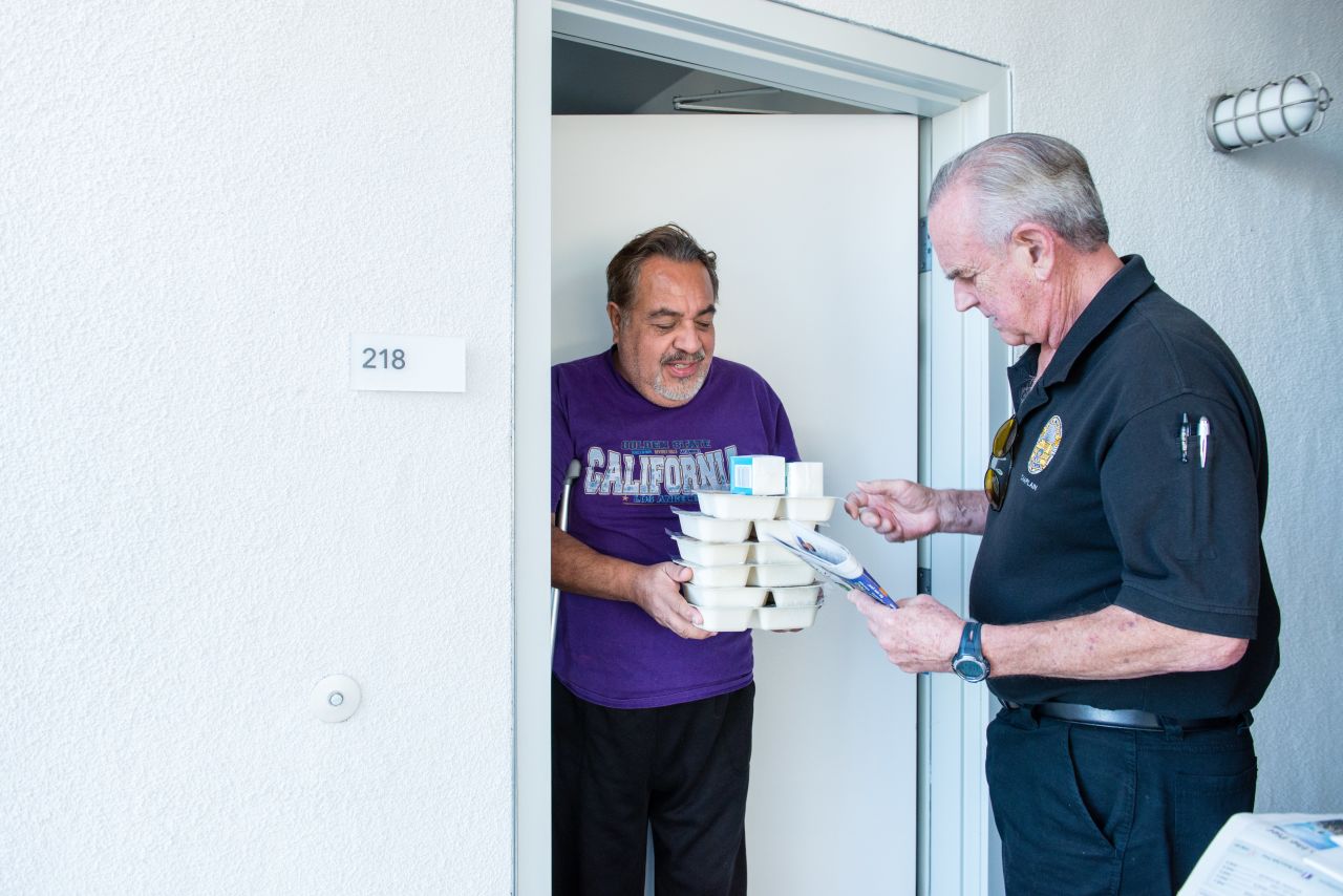 Meals on Wheels volunteer Mike Kearin delivers food to client Jesus Barron.