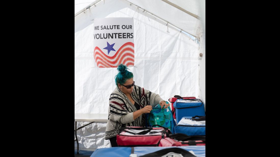 A volunteer at the Meals on Wheels in Santa Monica, California prepares  the meals she needs to deliver to clients on her route. 