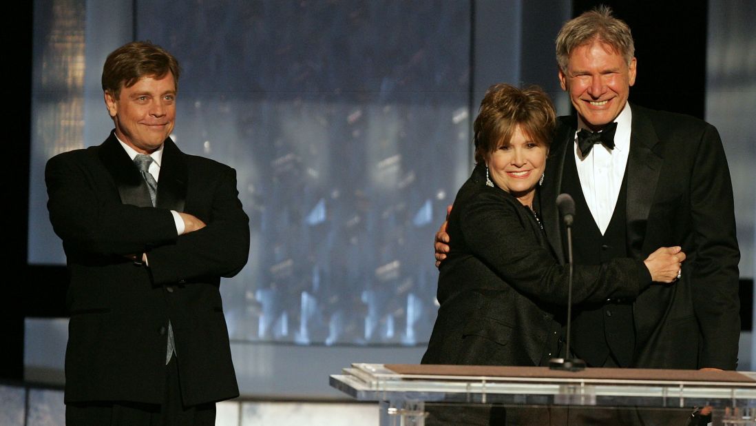 "Star Wars" trio Mark Hamill, left, Fisher and Harrison Ford speak during a tribute to filmmaker George Lucas at the 33rd American Film Institute Life Achievement Award event in Hollywood on June 9, 2005.