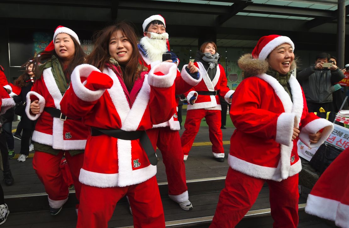 Protesters dressed as Santa urge the removal of impeached President Park Geun-hye on Saturday.