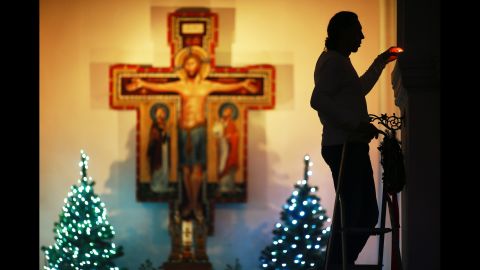 A worshiper lights a candle ahead of a traditional Christmas Eve Mass on December 24, in Vladimir, Russia.