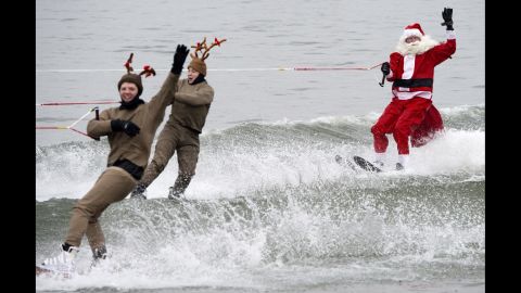 Members of the volunteer Water Skiing Christmas Show, dressed as Santa Claus and reindeer, water-ski on the Potomac River, in Alexandria, Virginia,on December 24.