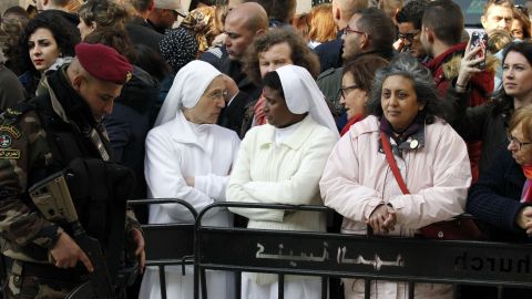 Two nuns are among the spectators taking part in the Christmas Eve celebrations on December 24, outside the Church of the Nativity, revered as the site of Jesus Christ's birth, in the biblical West Bank town of Bethlehem.