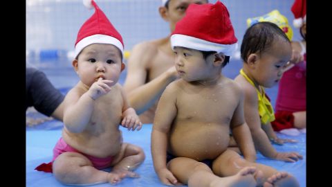 Babies attend a Christmas party held by a baby swimming club in Beijing on December 24.