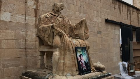 A religious statue vandalized by ISIS stands outside Mart Shmony Church in Bartella.