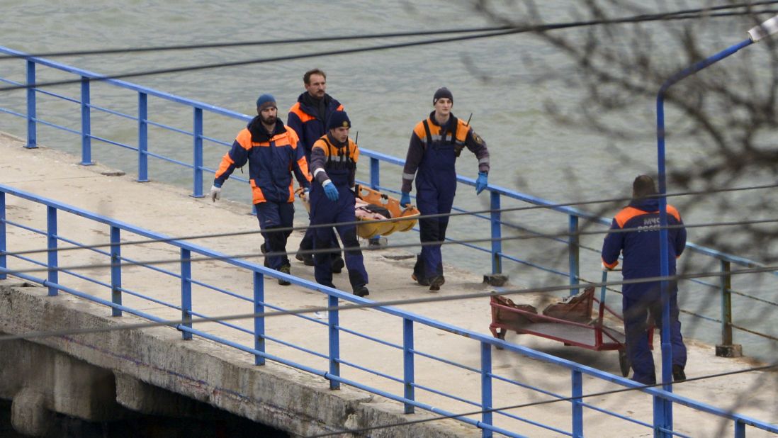 Russian emergency workers carry remains from the wreckage of the Tu-154 plane that crashed near Sochi on December 25. 