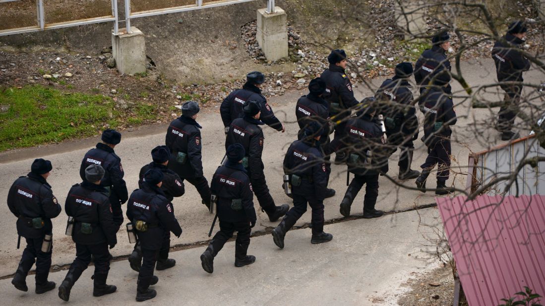 Russian police secure the area near where the plane crashed. In addition to the ensemble, the plane was carrying eight crew, eight soldiers and nine journalists.