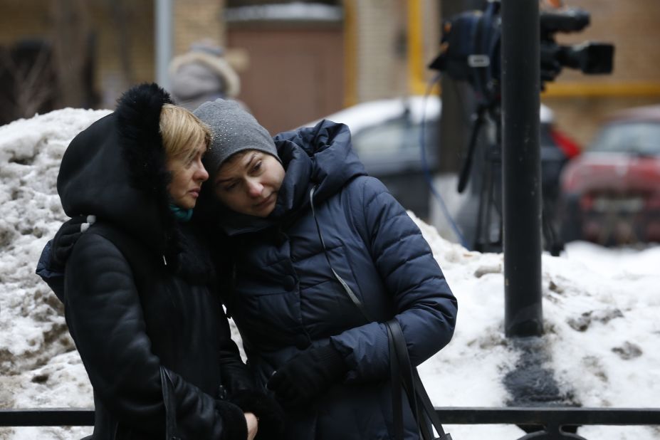 Two women stand outside Alexandrov Hall, a rehearsal room of the Alexandrov Ensemble, in Moscow on Sunday. The ensemble, established in 1928, has toured the world performing Russian folk songs, World War II anthems and patriotic music.