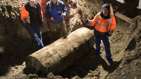 The bomb disposal team stand next to the World War II bomb they made safe in Augsburg, southern Germany, during a mass evacuation on December 25, 2016.