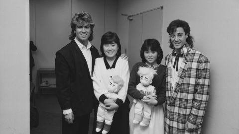 George Michael and Andrew Ridgeley of Wham! pose with fans.
