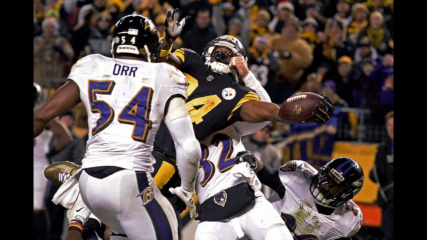 Pittsburgh wide receiver Antonio Brown reaches the ball across the goal line to score the winning touchdown in the final seconds of an NFL game against Baltimore in Pittsburgh, Pennsylvania, on Christmas day. Pittsburgh, which won 31-27, earned the AFC North title and will now go to the playoffs.