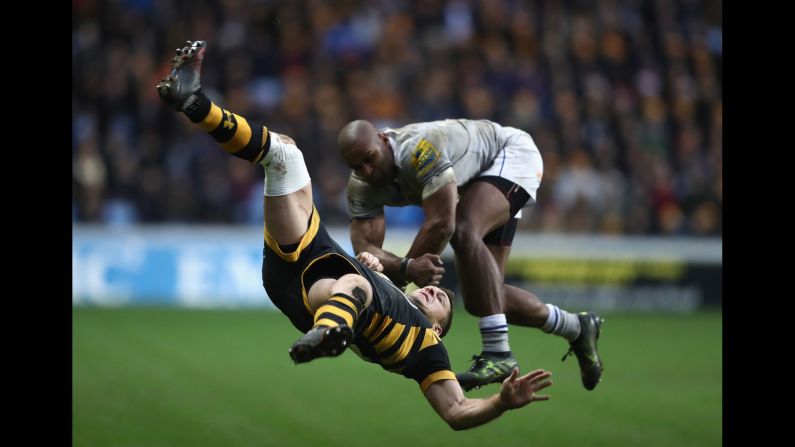 Jimmy Gopperth of the Wasps falls as he is challenged by Bath Rugby's Aled Brew during an Aviva Premiership match in Coventry, England, on Saturday. The Wasps won 40-26.