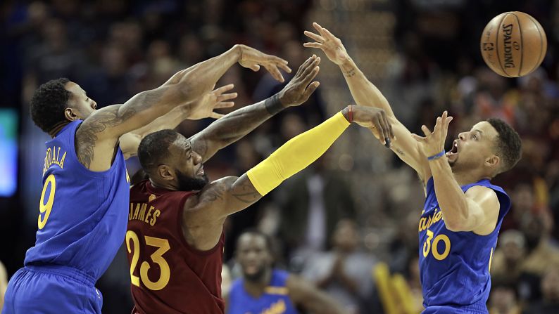 Cleveland's LeBron James makes a pass over Golden State's Stephen Curry during an NBA game in Cleveland on Christmas day. Golden State suffered a Christmas Day disappointment, losing 108-109 to Cleveland.