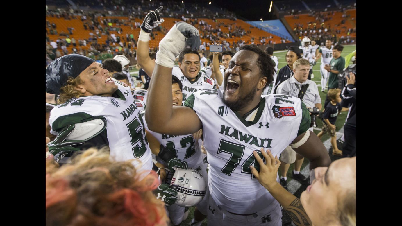 Hawaii offensive lineman RJ Hollis celebrates with teammates after they defeated Middle Tennessee 52-35 in an NCAA football game in Honolulu on Saturday.
