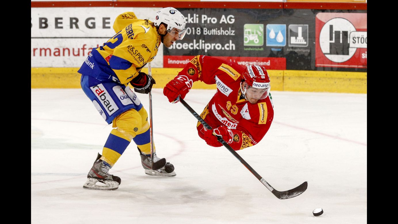 Davos' Noah Schneeberger, left, and Evgeni Chiriaïev of Langnau go for the puck during a Swiss league ice hockey game in Langnau, Switzerland, on Friday.