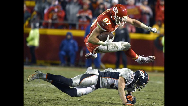 Kansas City tight end Travis Kelce leaps over Denver safety Justin Simmons during an NFL game in Kansas City, Missouri, on Sunday. Kansas City won 33-10.