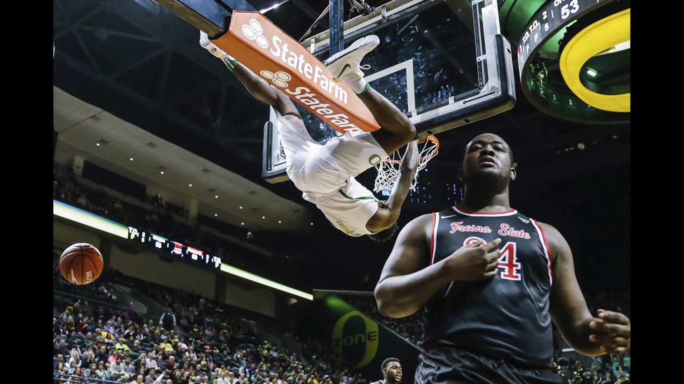 Oregon forward Jordan Bell hangs from the rim after a dunk against Fresno State center Terrell Carter II during an NCAA basketball game in Eugene, Oregon, last Tuesday.