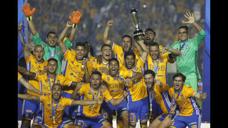 Tigres soccer players celebrate with the Mexican league trophy after defeating Club America in Monterrey, Mexico, on Sunday. Tigres won 3-0 on penalties after a 2-2 tie.