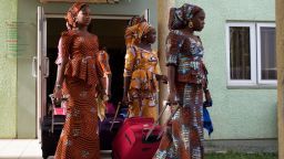 Girls leaving there accommodation, to head to Abuja airport.