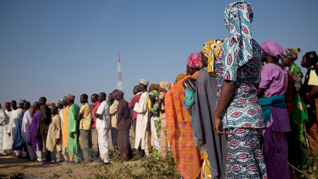 Family members line up on Friday to await the arrival of the girls, who were teenagers when they were taken but are now young women.