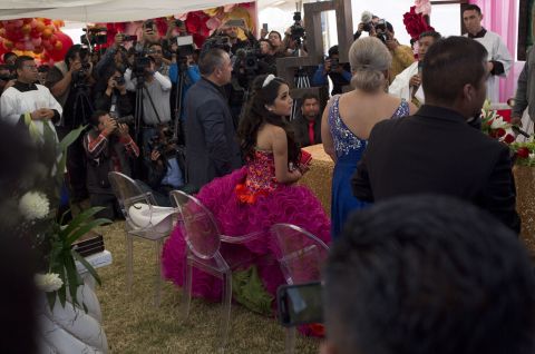 Rubi Ibarra makes her way through the crowd to her birthday Mass at her Quinceanera party on Monday. Millions of people responded to the invitation in rural Mexico after her parent's video asking "everybody" to attend went viral.