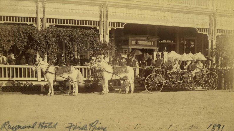The carriage that won first prize in 1891 stands outside the Raymond Hotel. Pasadena, California, has always been the home of the Rose Parade and the Rose Bowl Game.