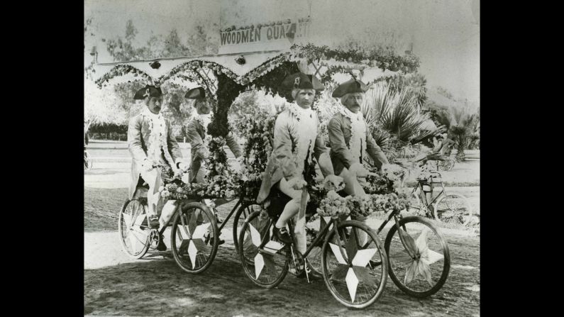 A group of men known as the Woodmen Quartet ride their bicycles together in the 1893 parade.