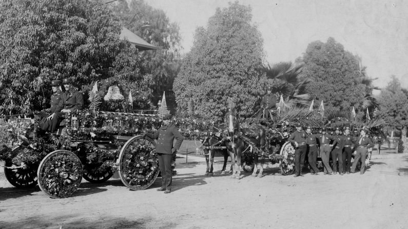 Firefighters pose with their department's entry in the 1896 parade.