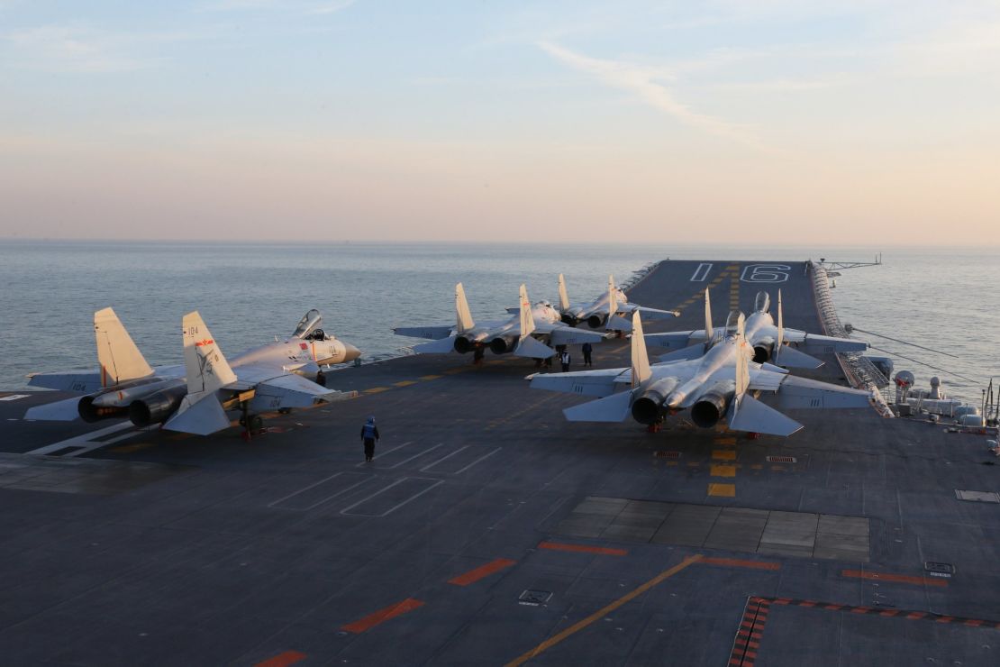 Chinese J-15 fighter jets wait on the deck of the Liaoning aircraft carrier during military drills in December.