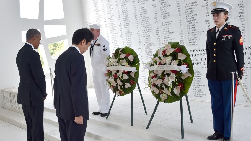 US President Barack Obama(L) and Japanese Prime Minister Shinzo Abe place wreaths at the USS Arizona Memorial December 27, 2016 at Pearl Harbor in Honolulu, Hawaii. 
Abe and Obama made a joint pilgrimage to the site of the Pearl Harbor attack on Tuesday to celebrate "the power of reconciliation. "The Japanese attack on an unsuspecting US fleet moored at Pearl Harbor turned the Pacific into a cauldron of conflict -- more than 2,400 were killed and a reluctant America was drawn into World War II. / AFP / Nicholas Kamm        (Photo credit should read NICHOLAS KAMM/AFP/Getty Images)
