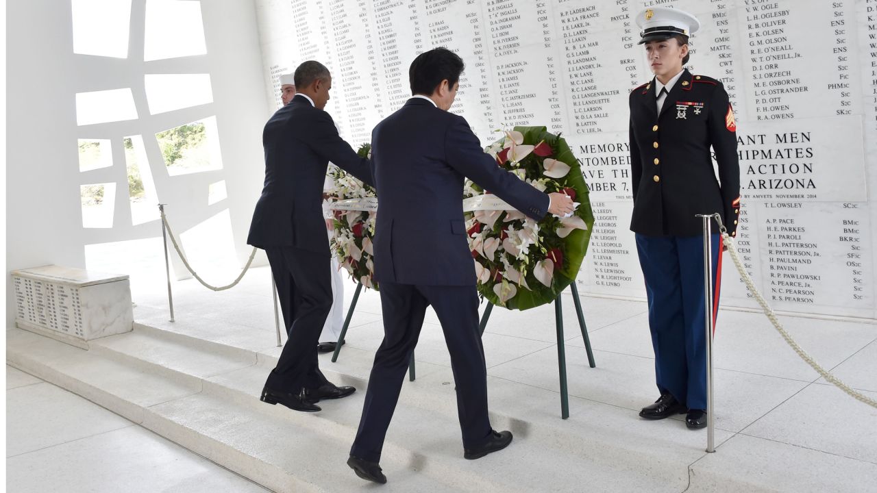 Obama and Abe place wreaths at the USS Arizona Memorial.
