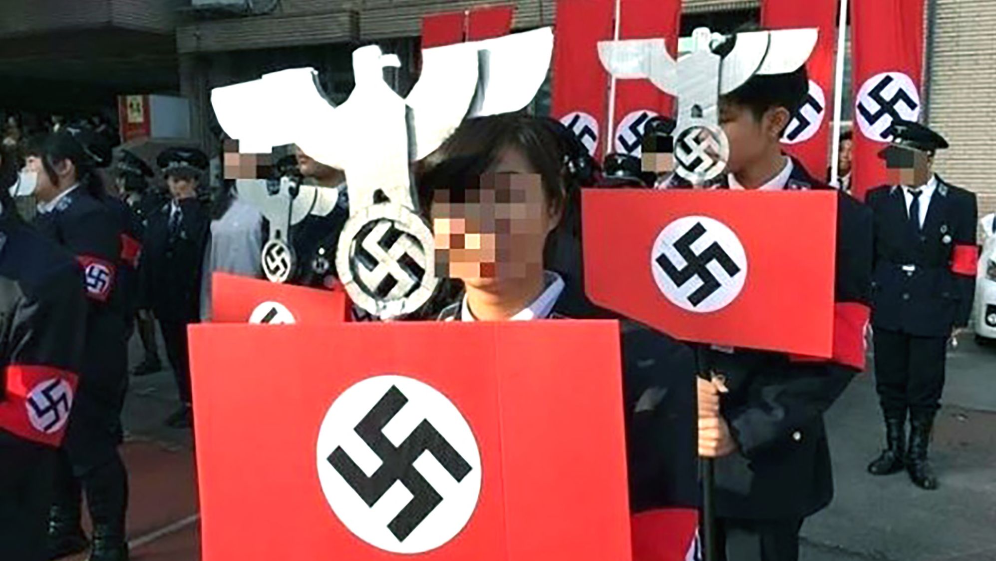 School students whose faces have been digitally obscured, wearing Nazi uniforms at the school in Hsinchu, western Taiwan, on December 23.