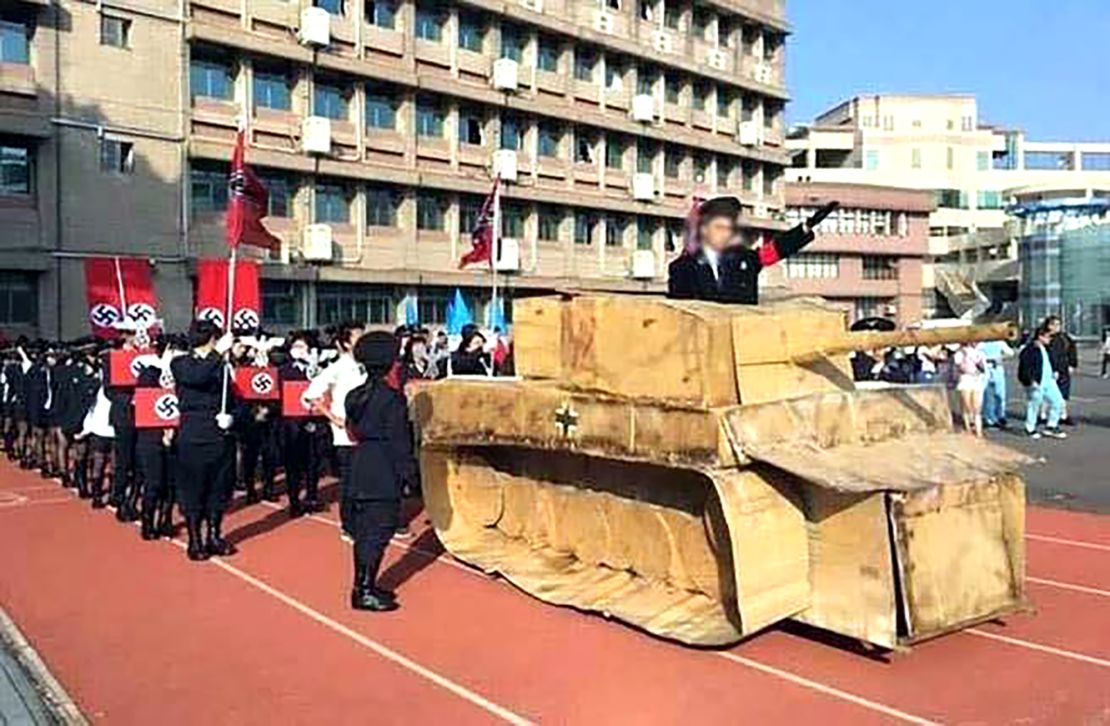 Some students waved a Nazi flag and shouting 'Sief Heil' while a history teacher - dressed as Hitler and standing in a tank made with cardboard - saluted the 'Nazi soldiers'.