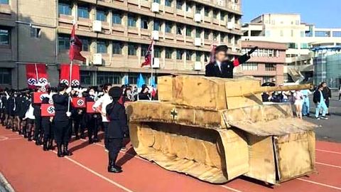 Some students waved a Nazi flag and shouting 'Sief Heil' while a history teacher - dressed as Hitler and standing in a tank made with cardboard - saluted the 'Nazi soldiers'.