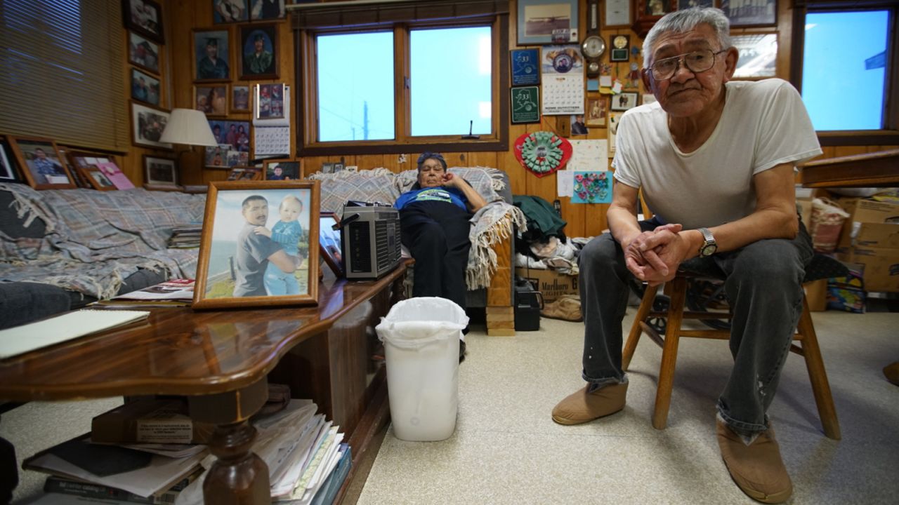 Shelton and Clara Kokeok, with a photo of their deceased son, Norman, who fell through the ice in 2007.