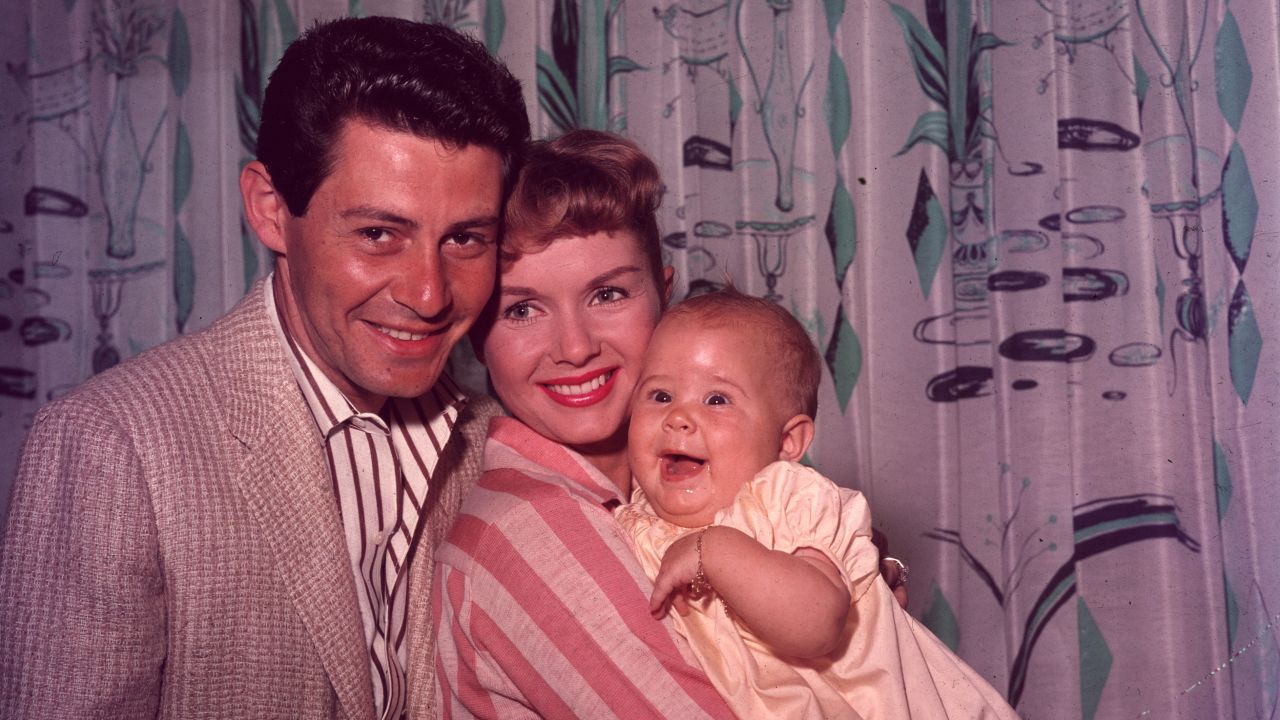 A family portrait of Fisher, Reynolds and daughter Carrie, circa 1957. 