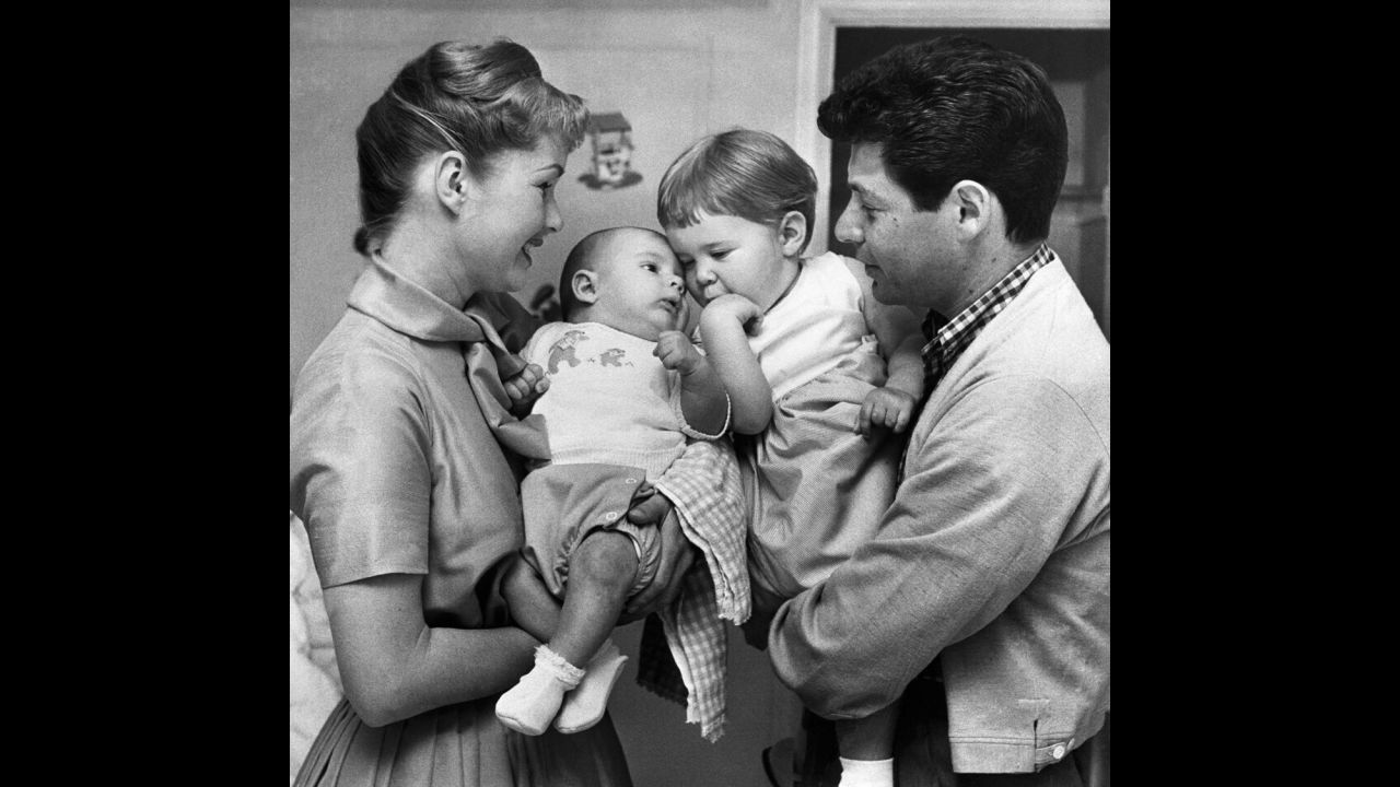 A family portrait with Debbie holding Todd and father Eddie holding Carrie.
