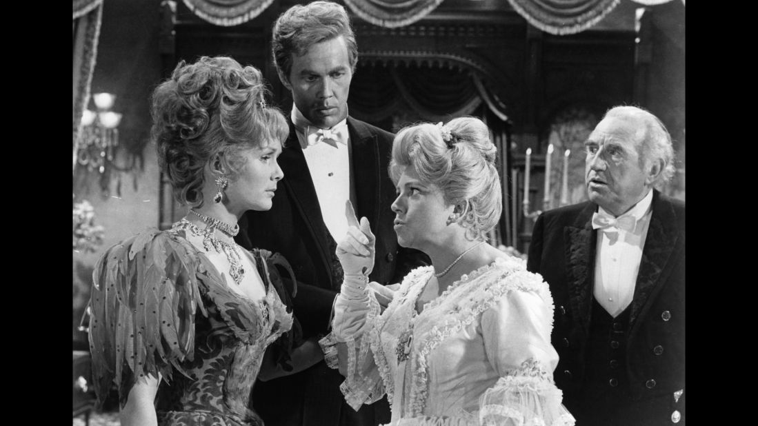 Hermione Baddeley points her finger at  Reynolds as Harve Presnell and Ed Begley watch during a scene from the 1964 film "The Unsinkable Molly Brown."  Reynolds was nominated for an Academy Award for Best Actress for the role.