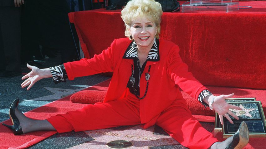 Veteran stage and film actress Debbie Reynolds poses with her second star on the Hollywood Walk of Fame, Monday, Jan. 13, 1997, in the Hollywood section of Los Angeles. Reynolds' latest film is "Mother," which opens nationwide this month. (AP Photo/Chris Pizzello)