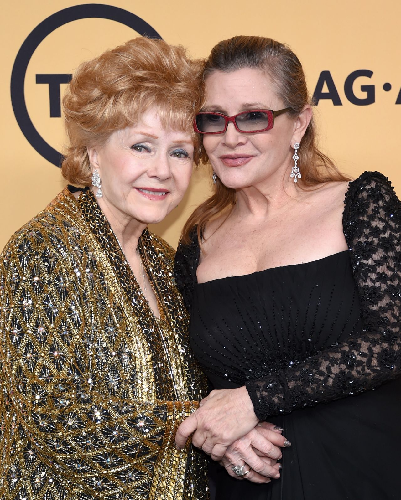 Reynolds poses with daughter Carrie Fisher after receiving the Screen Actors Guild Life Achievement Award on January 25, 2015, in Los Angeles.