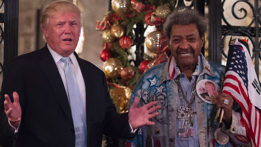 US President-elect Donald Trump, along with boxing promoter Don King,  answers questions from the media after a day of meetings on December 28, 2016 at Mar-a-Lago in Palm Beach, Florida.